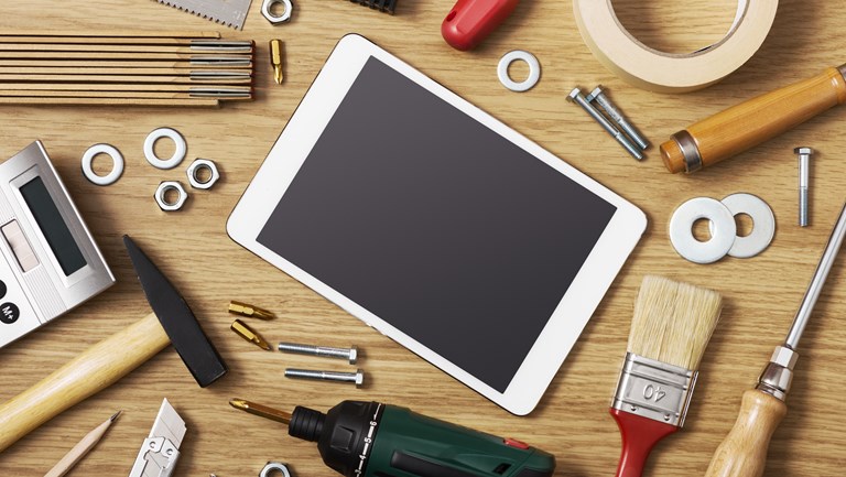 Tablet og værktøj på skrivebord